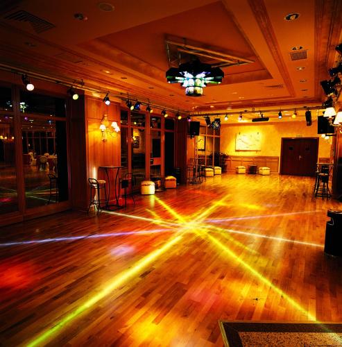 an empty room with a dance floor with lights on it at Hotel Conde Ansúrez in Valladolid