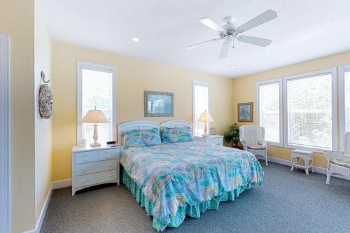 a bedroom with a bed and a ceiling fan at Abbeyfeale in St. George Island