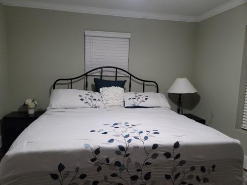 a bedroom with a bed with a floral blanket on it at Lovely oasis with private swimming pool 4,6,8 f deep in Gulf Breeze