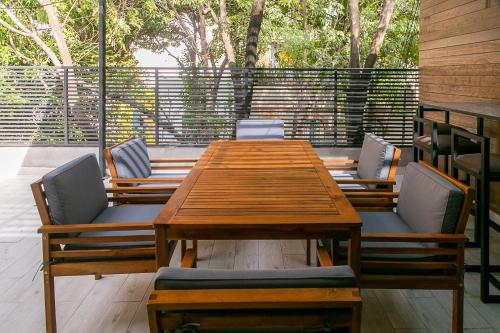 a wooden table and chairs on a patio at Lumina at Noma Condesa Mexico City in Mexico City