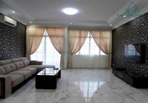 a living room with a couch and a flat screen tv at 99 Kelawei in George Town