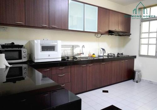 a kitchen with wooden cabinets and a microwave at 99 Kelawei in George Town