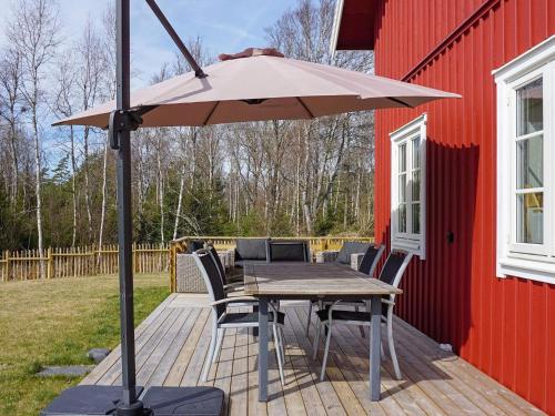 a table and chairs with an umbrella on a deck at 8 person holiday home in Grebbestad-By Traum in Grebbestad