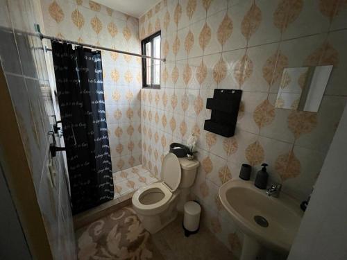 a bathroom with a toilet and a sink at Orimar in San Felipe de Puerto Plata