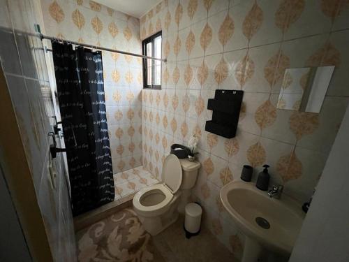 a bathroom with a toilet and a sink at Colimar in San Felipe de Puerto Plata