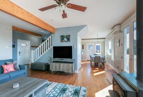 a living room with a blue couch and a flat screen tv at Grandview Get-A-Way home in White Salmon