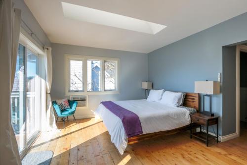 a bedroom with a bed and a chair and a window at Grandview Get-A-Way home in White Salmon