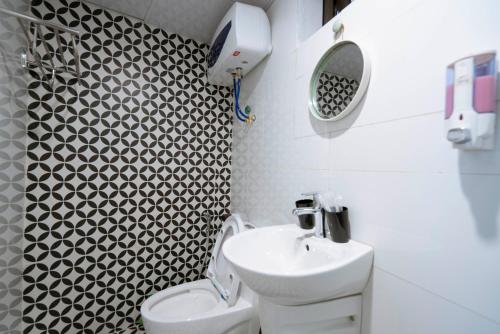 a bathroom with a sink and a toilet at Private room in Halong center in Ha Long