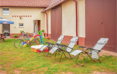 a group of chairs and bikes parked next to a house at Nice Apartment In Dominikowo With Wifi in Dominikowo