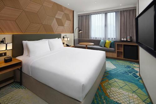 a hotel room with a large bed and a couch at Holiday Inn Cebu City, an IHG Hotel in Cebu City