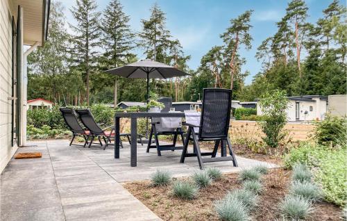 a patio with a table and chairs and an umbrella at Amazing Home In Vorden With Kitchen in Vorden