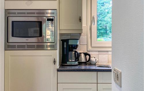a kitchen with a microwave and a sink at Amazing Home In Vorden With Kitchen in Vorden
