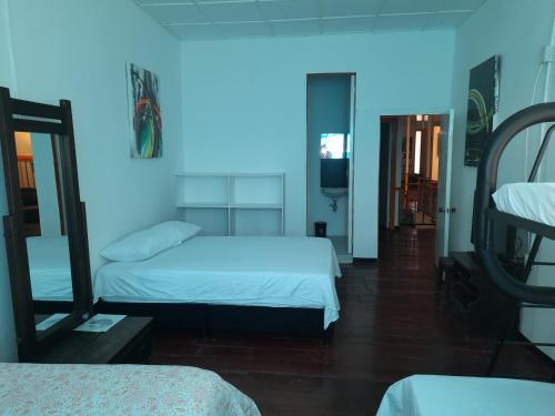 a bedroom with two beds and a blue light at Hotel Arte Santa Rosa in Santa Rosa de Cabal