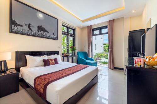 a hotel room with a bed and a tv at Banana Garden Villa in Hoi An
