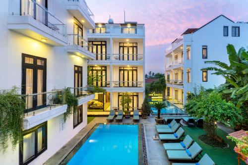 an exterior view of a building with a swimming pool at Banana Garden Villa in Hoi An