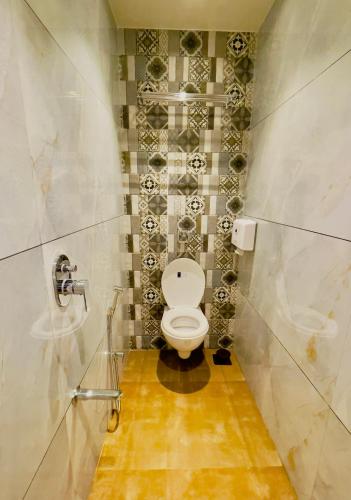 a bathroom with a white toilet in a stall at Hotel lime wood in Mumbai