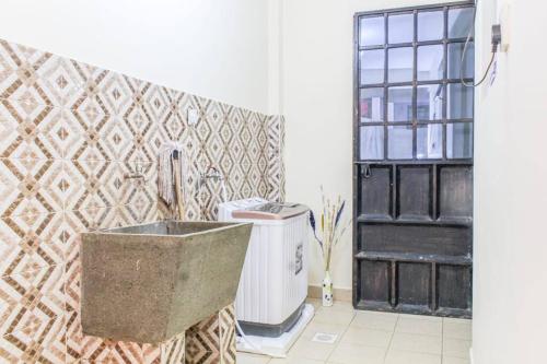 a bathroom with a stone sink and a window at The GEM - Kiambu road Best 2Bedroom apartment in Nairobi