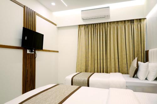 Tulsi Hotelにあるテレビまたはエンターテインメントセンター