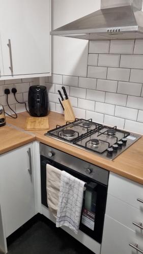 a kitchen with a stove with a towel on the oven at L.F.C Townhouse in Anfield in Liverpool