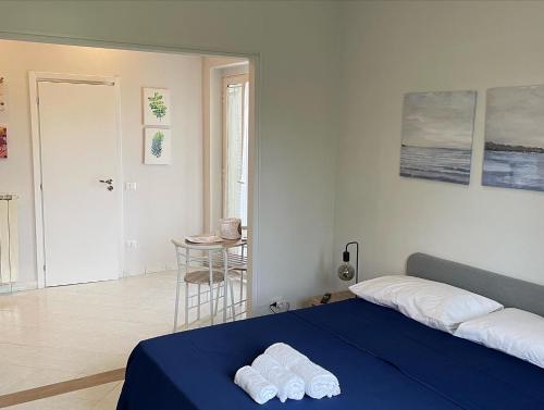 a bedroom with a bed with two towels on it at Villa Sibilla in Bacoli