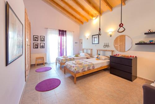 a bedroom with two beds and a mirror at Olive Private Villa Swimming Pool 5 BDR Kolymbia Rhodes in Kolimbia