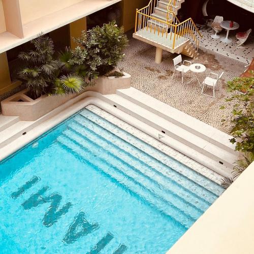 an overhead view of a swimming pool in a building at Miami Hotel Bangkok in Bangkok