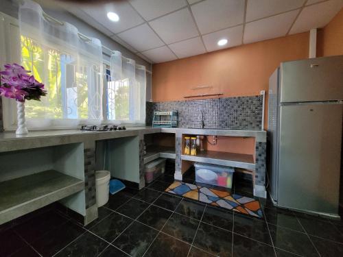 a kitchen with a sink and a refrigerator at Residence Casablanca in Ambatoloaka