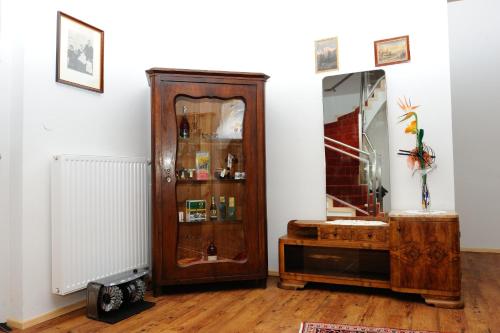 a room with a wooden cabinet and a mirror at Hotel-Gasthof-Fleischerei - Zur alten Post in Schwanberg