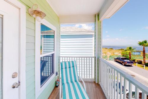 a porch with a blue and white chair and a window at Las Joyas Bayview Home #217 in Port Isabel