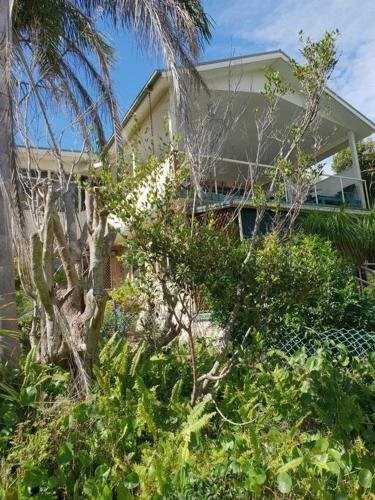 a house with trees and bushes in front of it at Crescent Head - Killick Glen - a couple's retreat in Crescent Head