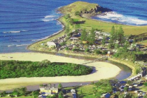 an aerial view of a beach next to the ocean at Crescent Head - Killick Glen - a couple's retreat in Crescent Head