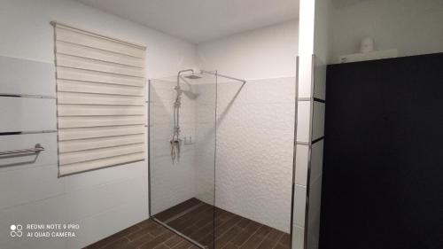a shower with a glass door in a bathroom at Lővér Vendégház Sopron in Sopron