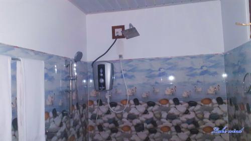 a room with a wall with a painting of animals at Lake Wind in Habarana