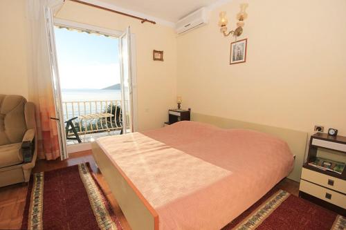 a bedroom with a bed and a view of the ocean at Family friendly apartments with a swimming pool Okrug Donji, Ciovo - 8072 in Okrug Donji