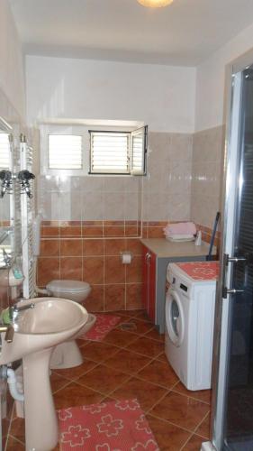 a bathroom with a sink and a washing machine at Apartment Sali 8153b in Sali