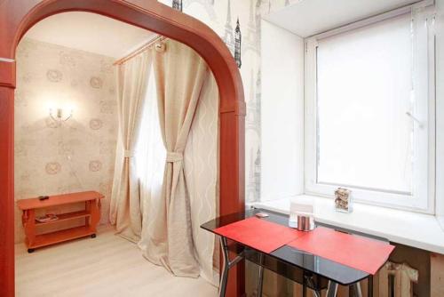 a bathroom with a shower with a red counter and a window at ROTAS On Moskovsky 165 in Saint Petersburg