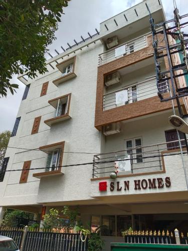 a building with a sign that reads sun homes at HOTEL SLN Homes in Bangalore