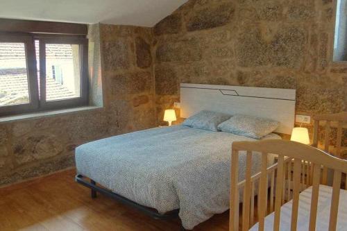 Postel nebo postele na pokoji v ubytování Cuberto Darriba Casa restaurada en Canedo