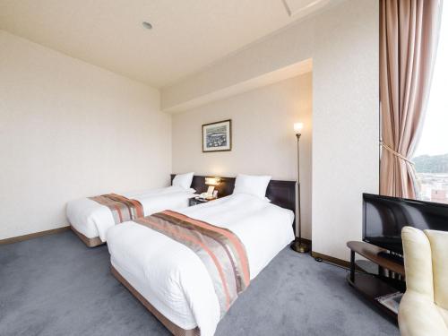 Tabist Abashiri Central Hotelにあるベッド