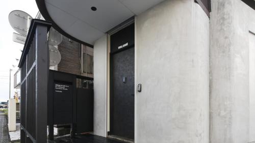 a row of black doors on a building at SLEEEP Fuji in Fujinomiya