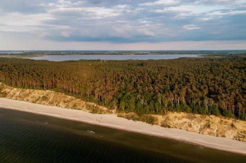 an aerial view of a beach and a body of water at White & Black in Kołczewo
