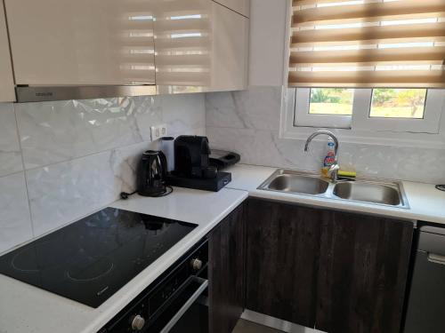 a kitchen with a sink and a counter top at Rhodes Comfort Luxury Apartment in Rhodes Town