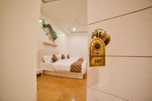 a door knob to a bedroom with a bed at The Bheemgarh in Jaisalmer