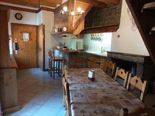 a kitchen with a table and chairs and a counter at Chalet La Ferme d'Henriette, à Samoëns in Samoëns