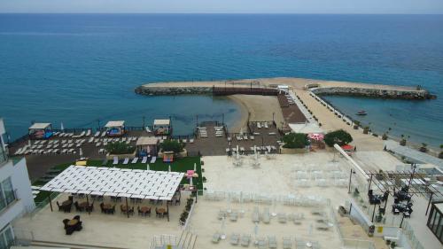 an aerial view of a beach with tables and chairs at Ada Beach Hotel in Kérynia
