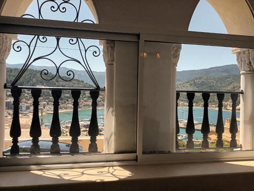 a window view of the beach from a house at La Castillita - Port de Soller Seaview Apartment - Perfect for Couples in Port de Soller