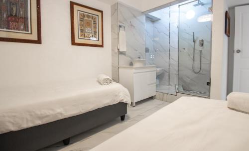 a bathroom with two beds and a shower at 8 Bronze Beach Umhlanga Rocks in Durban