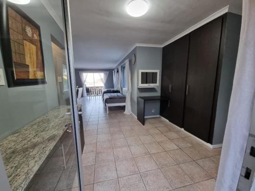 a hallway with a living room with a couch and a television at Knysna Lagoon View in Knysna
