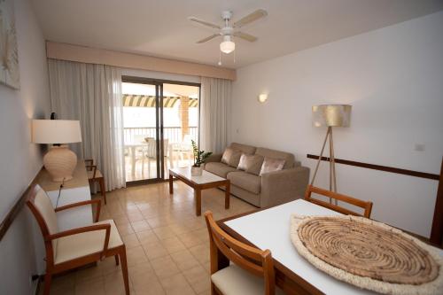 a living room with a couch and a table at Apartamentos María Cristina Beach in Benidorm