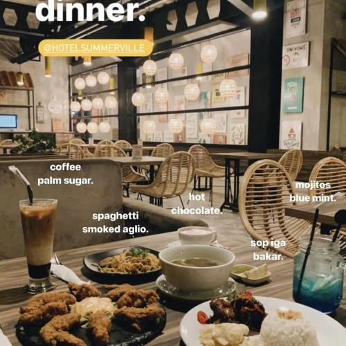 a table topped with plates of food on top at Hotel Summerville in Majalengka